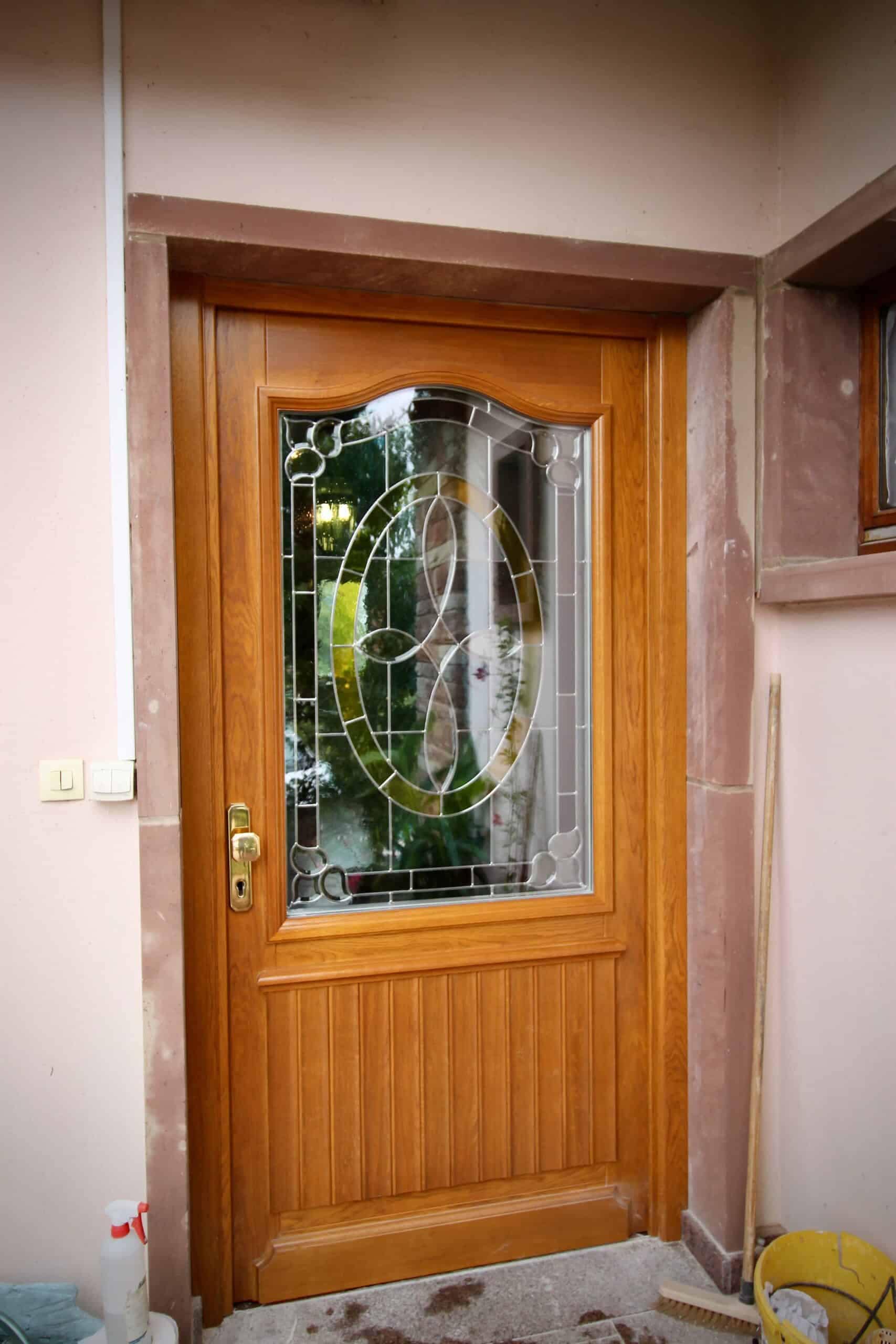 La porte d’entrée en bois et son vitrail
